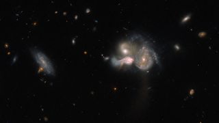 A Hubble image showing three galaxies in the constellation Boötes heading for a violent collision that will birth a new galaxy. 
