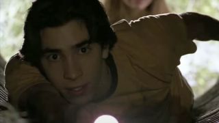 Justin Long as Darry looking down the Creeper's pipe with a flashlight in Jeepers Creepers