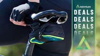 Cyclist's hand on saddle with seat bag underneath