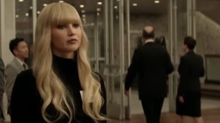 Jennifer Lawrence with long blonde hair, wearing black in Red Sparrow.