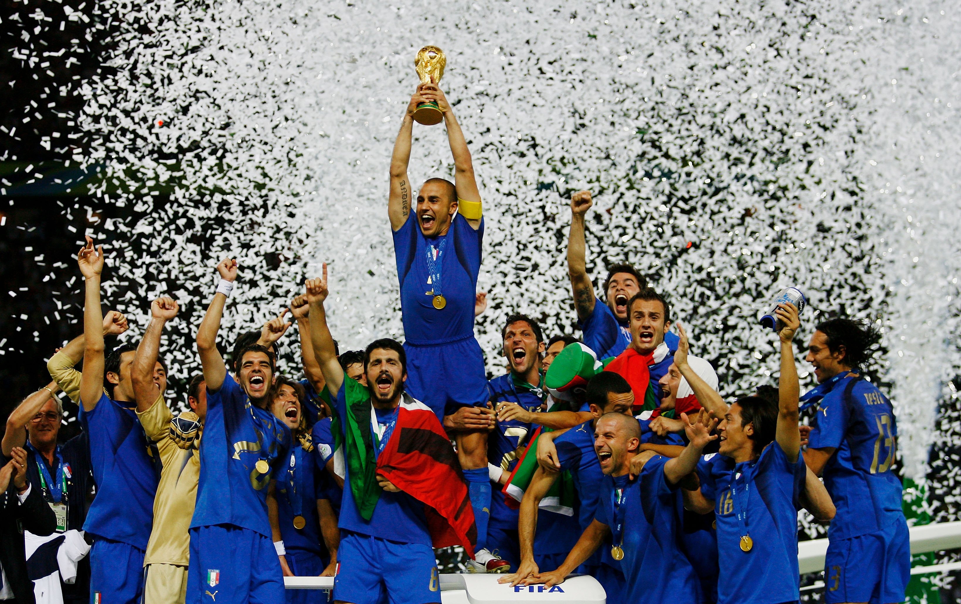 Italy captain Fabio Cannavaro holds aloft the World Cup trophy as he and his team-mates celebrate victory on penalties against France in the 2006 final in Berlin.