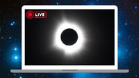 A photo of the sun during totality is shown on a white laptop's screen as it floats against a starry deep-space background.