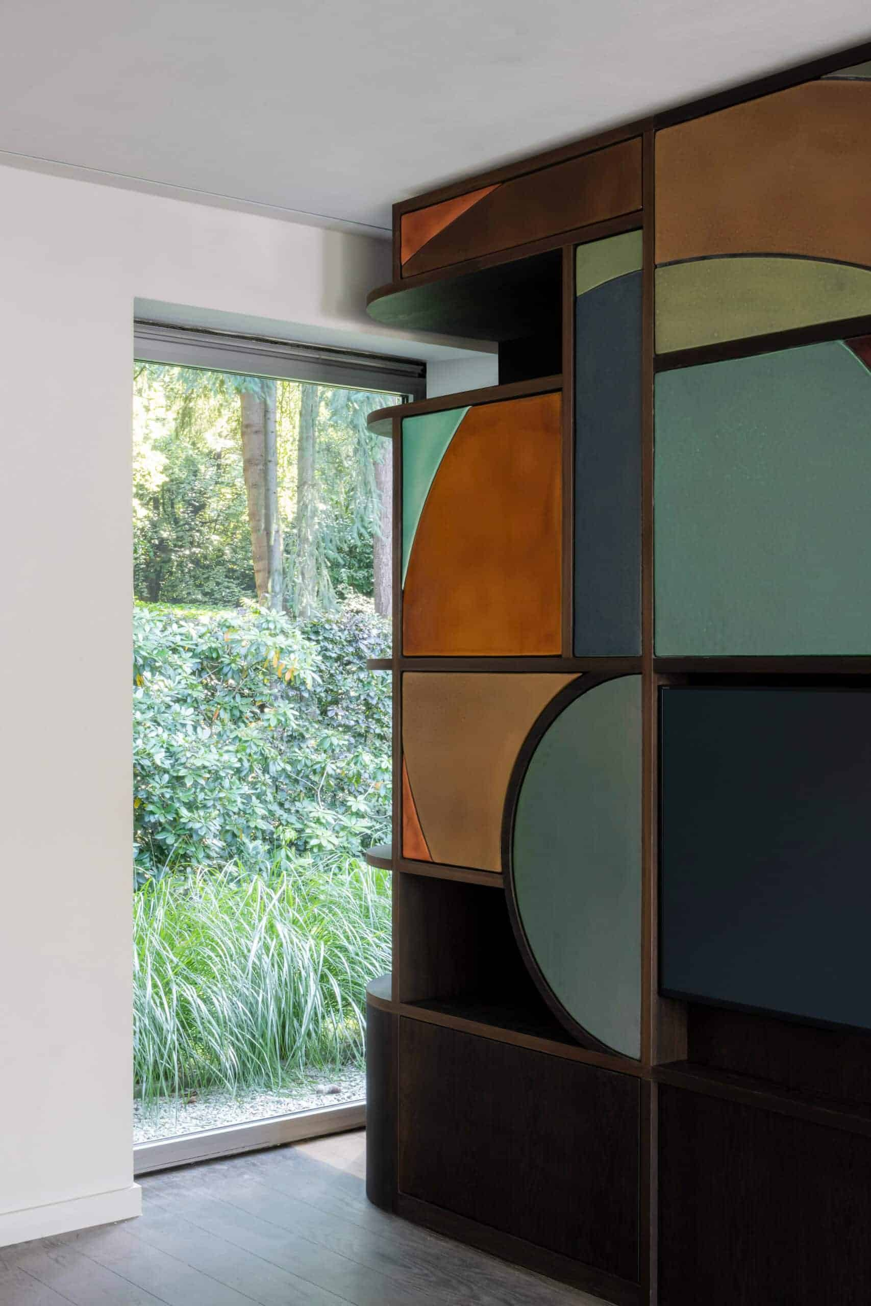 a TV wall with ceramic art deco inspired shapes built in containing storage