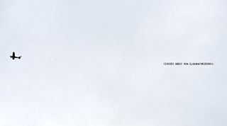 A plane trailing a banner protesting against Everton's owners flies over Goodison Park during the Premier League match between Everton and Arsenal on 4 February, 2023 in Liverpool, United Kingdom.