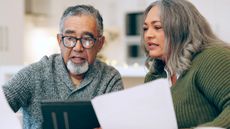 Senior couple looking through documents at home