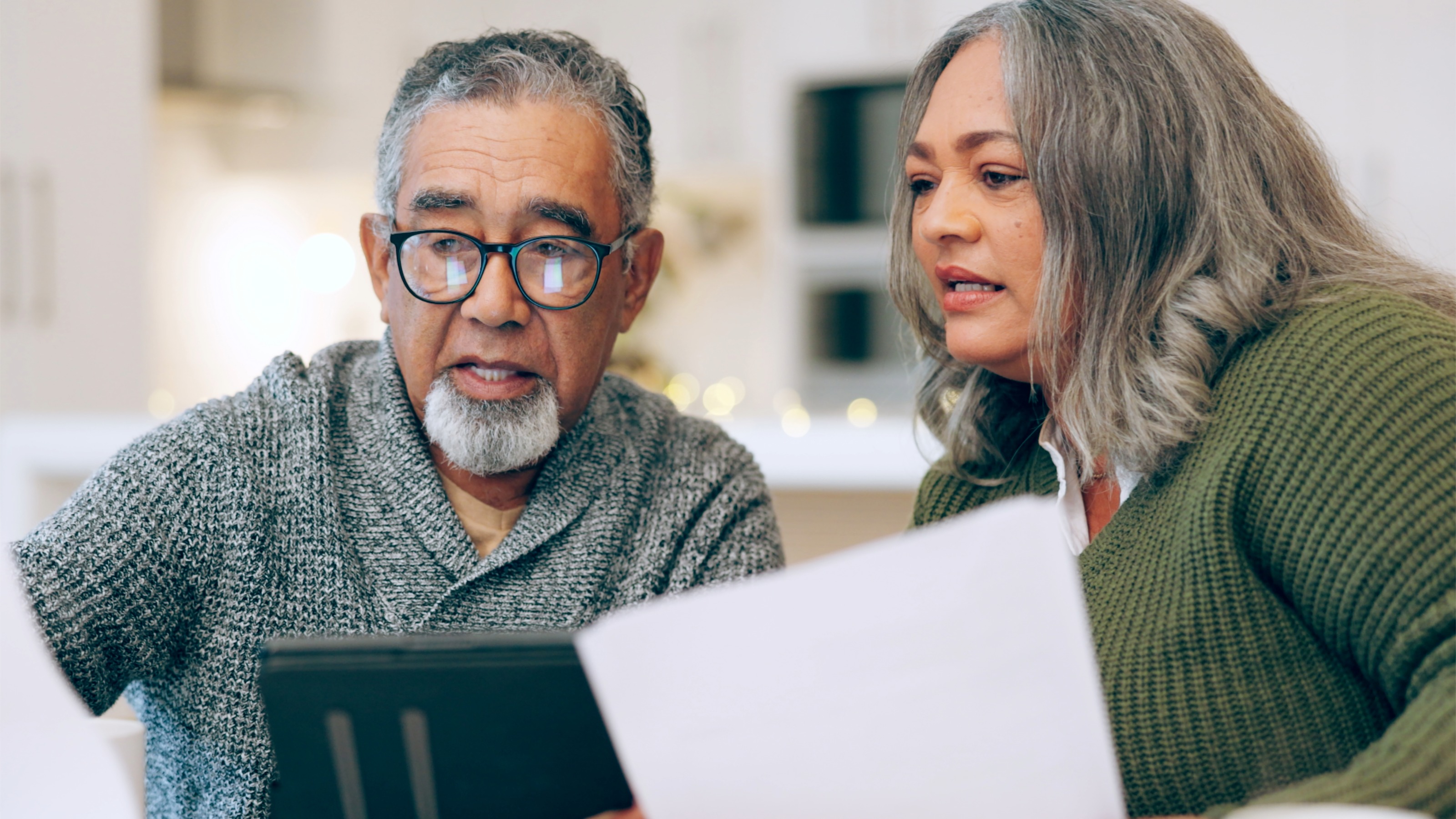 Senior couple looking through documents at home
