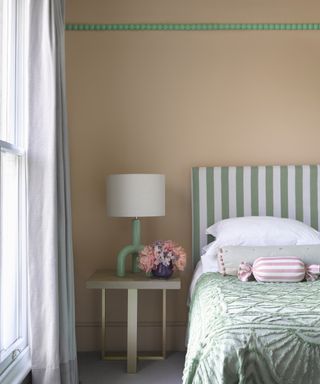 discovering your interior design style, coral and green bedroom, green and white stripe headboard, green throw, modern side table with lamp, flowers, apple green beading along picture rail