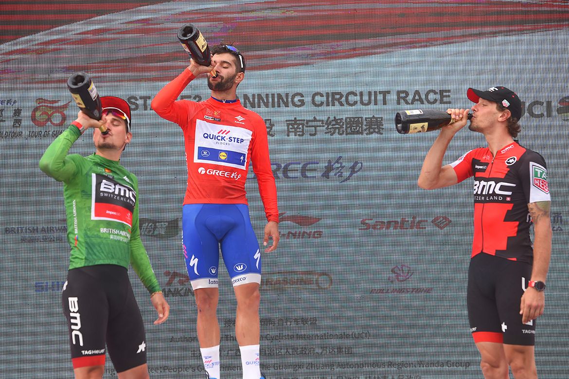 Fernando Gaviria and the BMC duo swig the bubbly on the podium