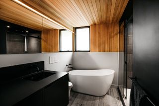 A bathroom with wooden ceiling