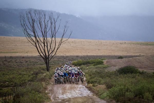 The lead bunch leaves Caledon during stage 5 of the 2012 Absa Cape Epic Mountain Bike stage race from the Overberg Primary &amp; High School in Caledon to Oak Valley Wine Estate in the Elgin Valley, South Africa on the 30 March 2012