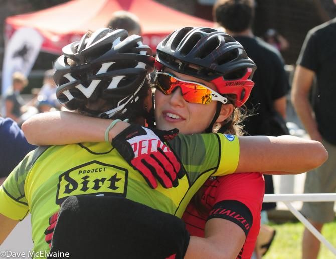 Shayna Powless and Kate Courtney embrace at the finish