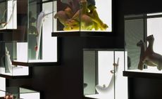 Beside the Corian ribbon, the gallery’s jewelry collection and small objects are displayed in illuminated, wall-mounted boxes. 