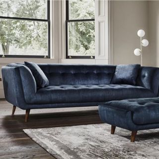 Picture of blue sofa and matching footstool
