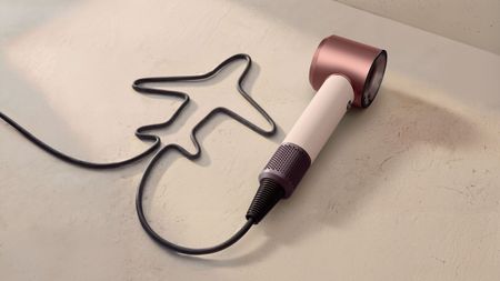 Dyson Supersonic Travel hair dryer with cable arranged in the shape of a plane