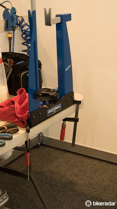 Most teams bring some form of basic truing stand with them - such as this Park Tool Home Mechanic model