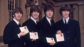 British pop group The Beatles, from left to right; Ringo Starr, John Lennon (1940 - 1980), Paul McCartney and George Harrison (1943 - 2001), outside Buckingham Palace, London, after receiving their MBEs (Member of the Order of the British Empire) from the Queen