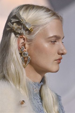 Model at Valentino wearing hair accessories, a key Spring/Summer 2025 fashion month beauty look