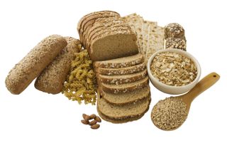Close up of assorted grains and bread - stock photo