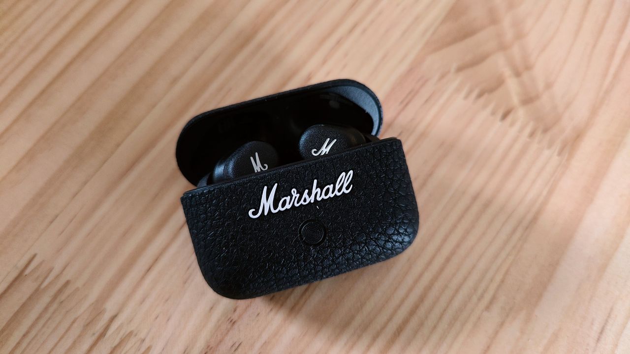 Marshall Motif II ANC review: earphones in charging case on a wooden table