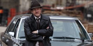 Gotham Donal Logue sits, arms crossed, on the hood of his car