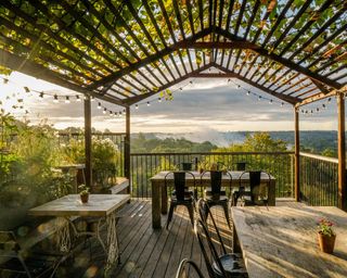 wooden pergola over a balcony with view over countryside