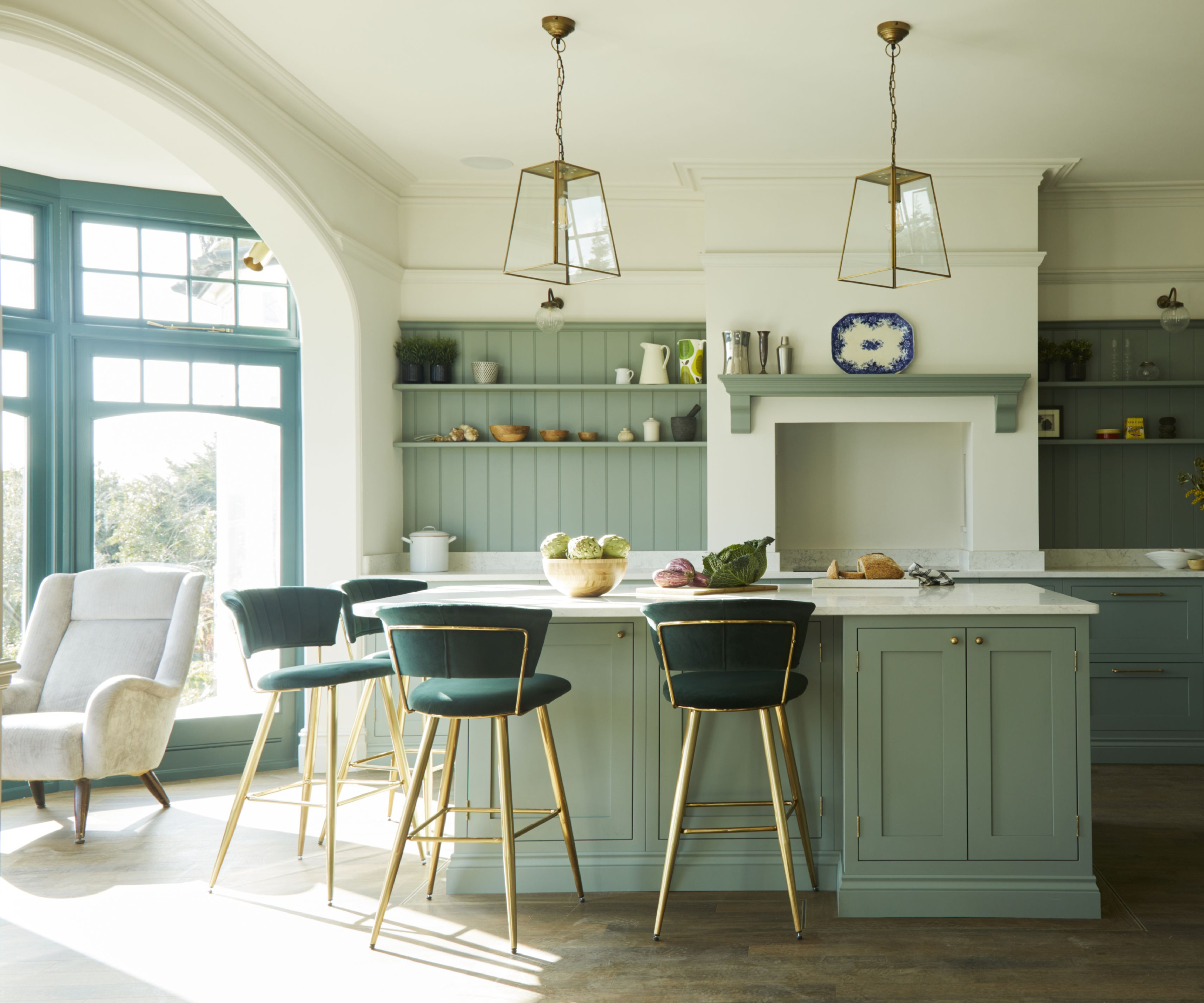 sage green kitchen cabinets paired with off white walls, island in same shade