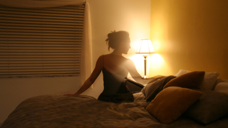 Woman about to get into bed