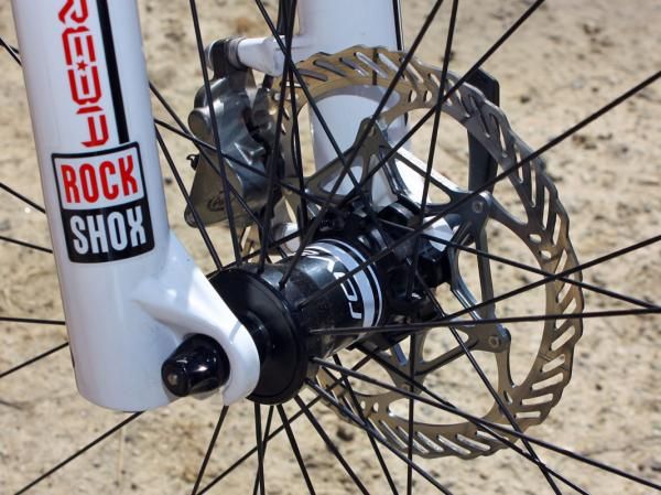 The front hub features interchangeable end caps that work with standard quick-release or 15/20mm thru-axle dropouts.