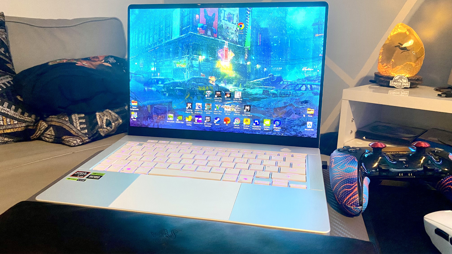 Asus ROG Zephyrus G14 (2025) sitting on a sofa.