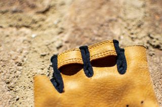 A pair of Pearl Izumi Pro Air mitts on a brick wall