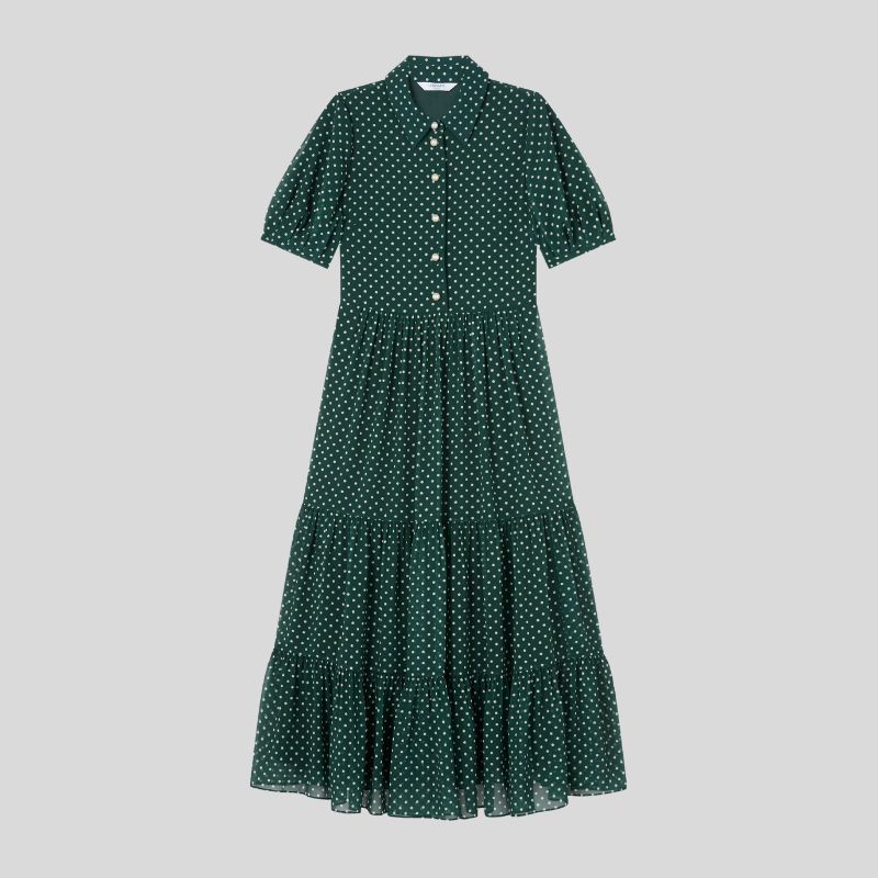 A cutout of a green and white polka dot dress