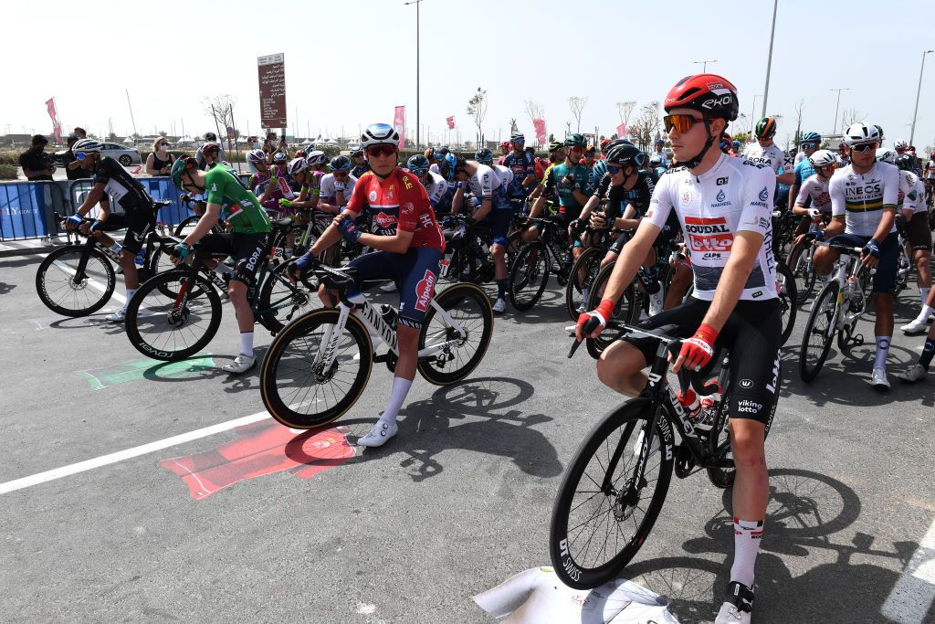 ABU DHABI UNITED ARAB EMIRATES FEBRUARY 21 LR Dmitrii Strakhov of Russia and Team Gazprom Rusvelo most aggressive jersey Sam Bennett of Ireland and Team Bora Hansgrohe green points jersey Jasper Philipsen of Belgium and Team AlpecinFenix red leader jersey and Xandres Vervloesem of Belgium and Team Lotto Soudal white best young jersey prior to the 4th UAE Tour 2022 Stage 2 a 176km stage from Hudayriyat Island to Abu Dhabi Breakwater UAETour WorldTour on February 21 2022 in Abu Dhabi United Arab Emirates Photo by Tim de WaeleGetty Images