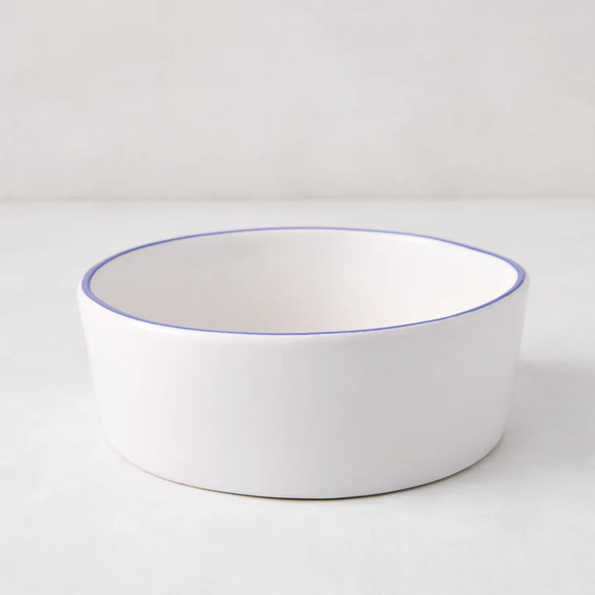 White stone soup bowl with a Pacific-blue rim