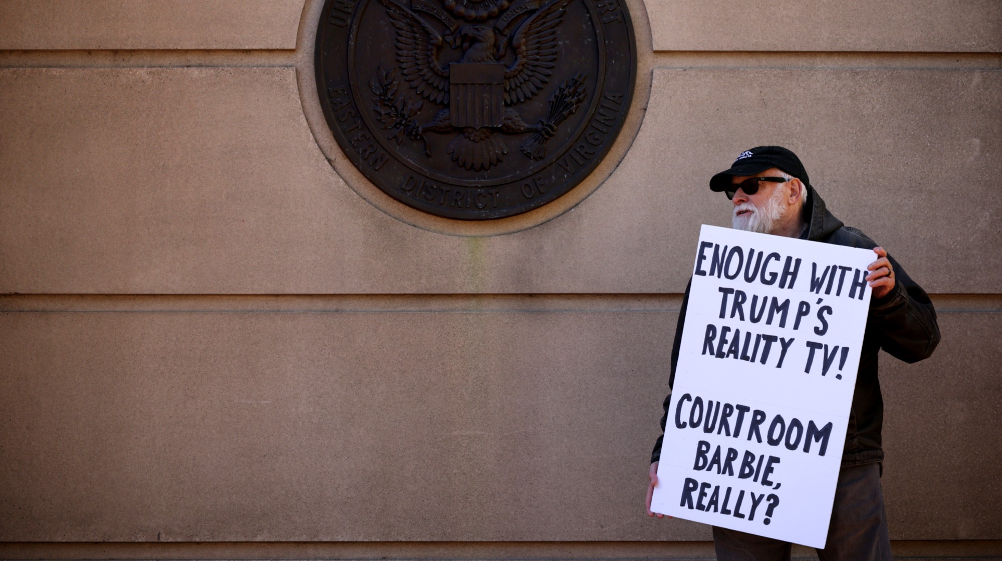 ALEXANDRIA, VIRGINIA - NOVEMBER 13: A protester holds a sign outside the Albert V. Bryan United States Courthouse on November 13, 2025 in Alexandria, Virginia. The court is hearing oral argument challenging the appointment of U.S. Attorney for the Eastern District Lindsey Halligan, who signed the indictments against former FBI Director James Comey and New York Attorney General Letitia James, was illegitimate. (Photo by Alex Wong/Getty Images)