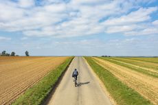 A cyclist on an empty country road in England