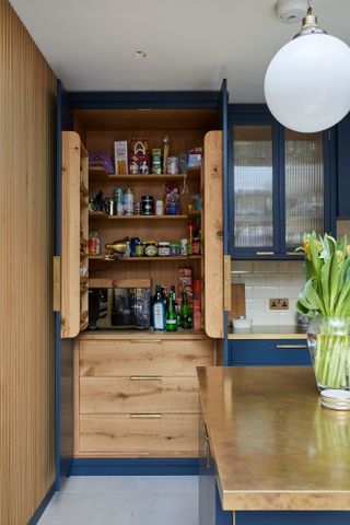 dark blue kitchen with pantry larder unit