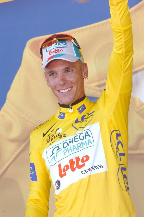 Philippe Gilbert waves to the crowd after pulling on the yellow jersey