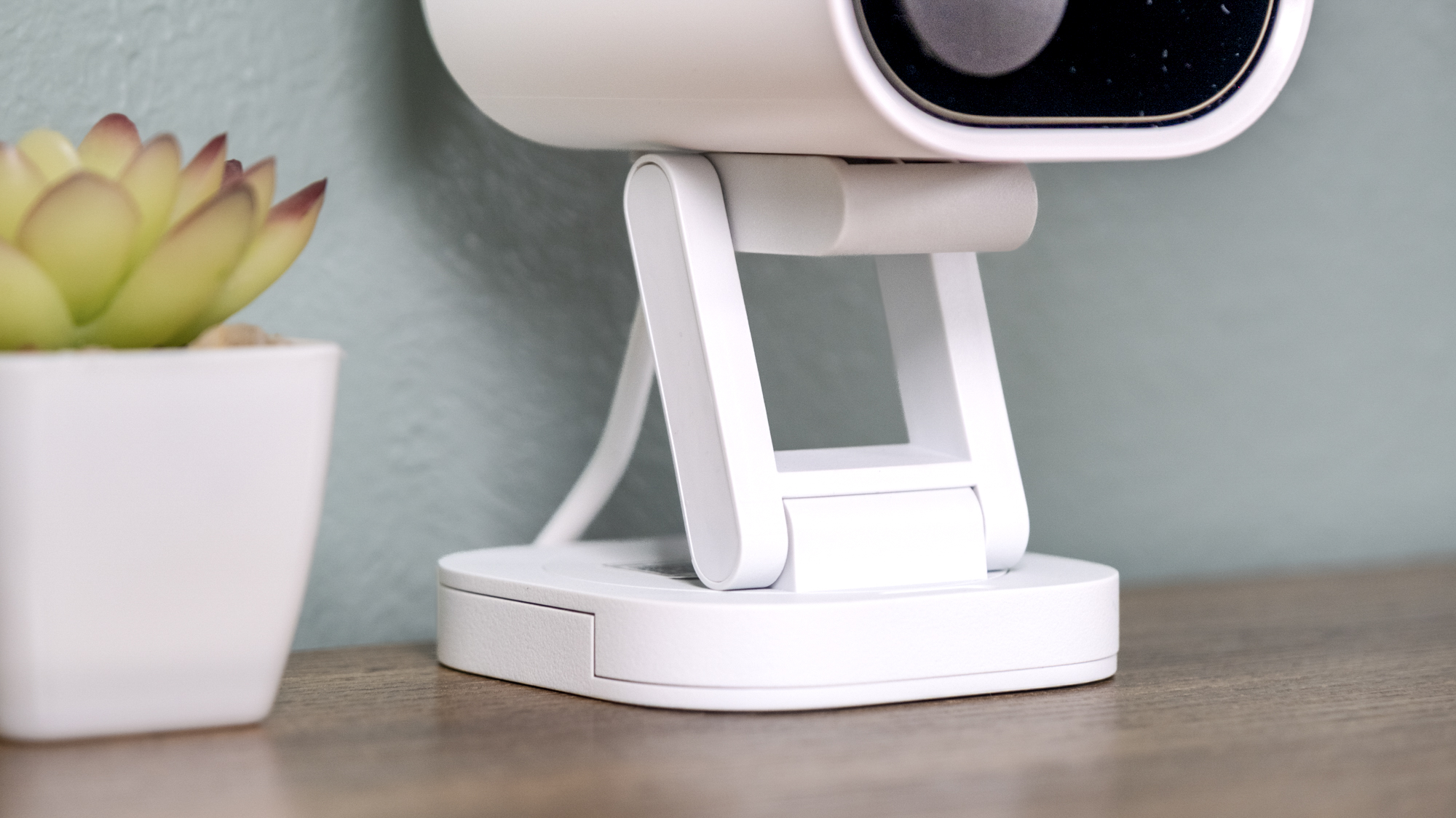 Aqara Camera Hub G5 Pro on a shelf with a small cactus.