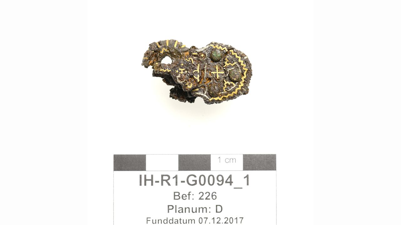 Fine silver wires inlaid into the iron buckle of the sword belt suggest this grave dates from the seventh century, when this ornamental craft was at its height.