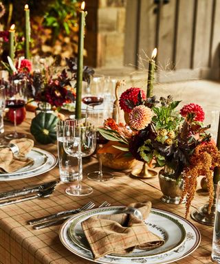 fall tablescape with plaid tablecloth and harvest vegetables as center piece decor