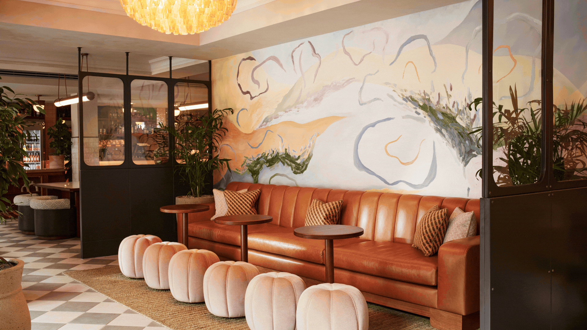 A GIF of a hotel lobby, a restaurant, a living room, a bedroom, and a kitchen island with breakfast