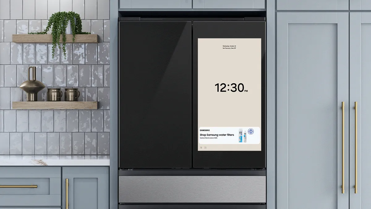 screen on a fridge displaying the time and an advert for Samsung water filters