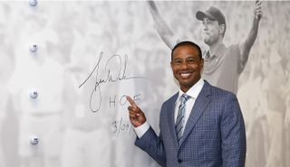 Tiger points after signing