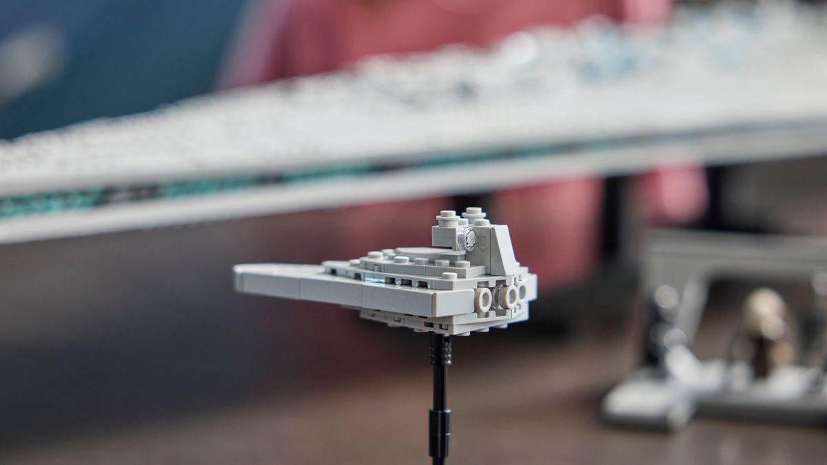 Lego Star Destroyer mini ship on a stand beside the massive Executor kit