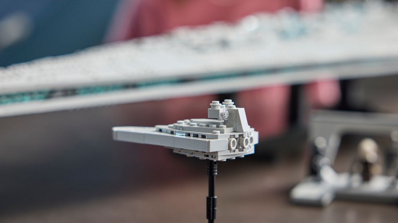 Lego Star Destroyer mini ship on a stand beside the massive Executor kit