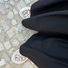 Debora Rosa wearing white crochet flats from Hyova. 