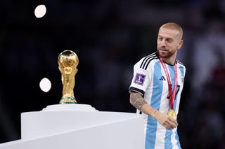 Alejandro Gomez of Argentina walks past the The FIFA World Cup Qatar 2022 Winner's Trophy after the team's victory during the FIFA World Cup Qatar 2022 Final match between Argentina and France at Lusail Stadium on December 18, 2022 in Lusail City, Qatar. (Photo by Clive Brunskill/Getty Images)