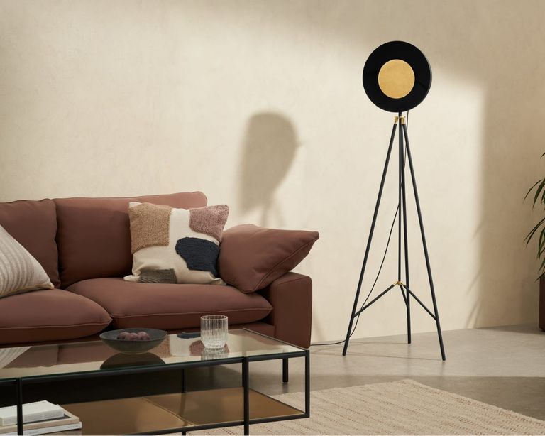 Made sale Ward Tripod Floor Lamp in living room beside pink sofa with cushions and black metal coffee table