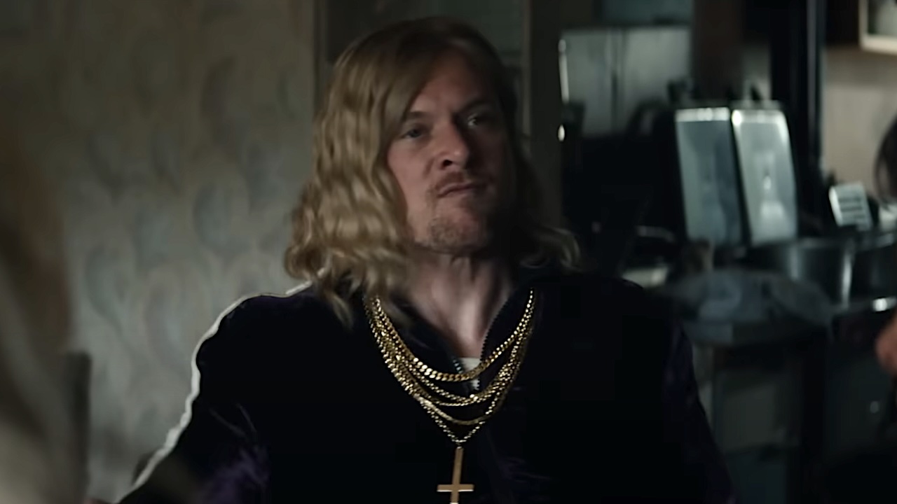 Jimmy angry with gold chains and upside down cross around his neck in 28 Years Later: The Bone Temple