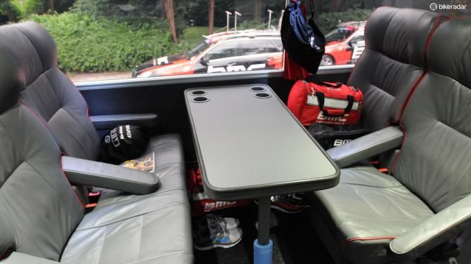 The riders each choose where they prefer to sit, populating it with their daily kit. Note the padding on the metal table leg to protect precious pro legs